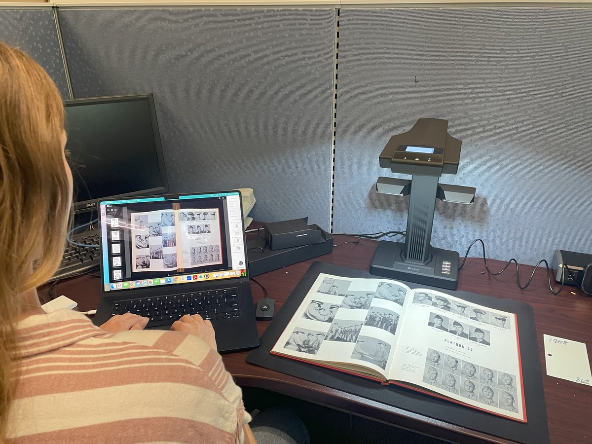 Team member scanning yearbook