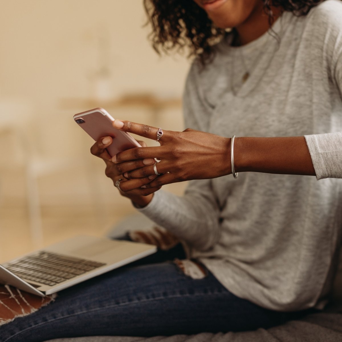 woman checking cell phone for two factor authentication code